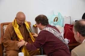 Professor Scherer handing a khatag to the Venerable Abbot Hsin Ting